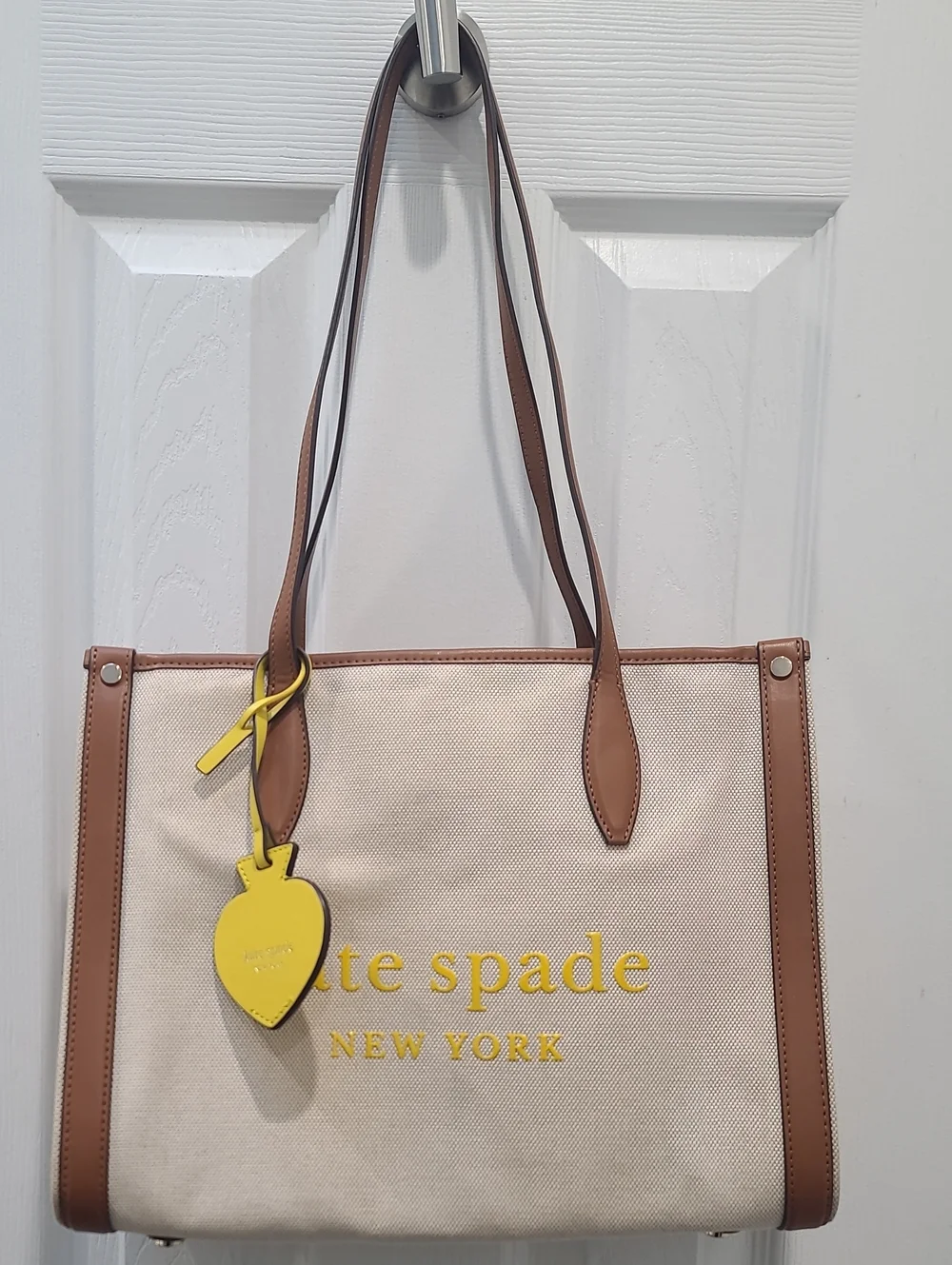 kate spade Beige Canvas Tote with Brown Trim and Yellow Charm